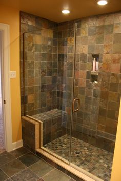 a walk in shower sitting inside of a bathroom