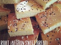 rolls with sesame seeds are piled on top of each other and the words, roll afghan sweet bread