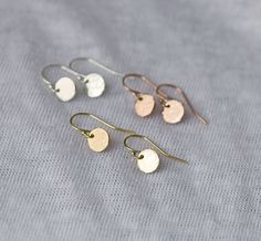 "Minimal dainty disk earrings. Tiny and so cute, these adorable little drops are perfect for everyday. If lightly hammered, they shimmer and shine even more. ❤ THE PERFECT ADORABLE AFFORDABLE GIFT * completely effortless & versatile  * meticulous attention to detail * stamping is done completely by hand. so personal * each order marked \"gift\" will come beautifully gift-wrapped :) E A R R I N G - D E T A I L S --- what you get  * quality 7mm discs (about 1/4\")  * a bit over 1/2\" from the top Disk Earrings, Earrings Everyday, Gold Dangle Earrings, Shimmer And Shine, Disc Earrings, Matching Jewelry, Handmade Jewelry Gift, Disc Necklace, Everyday Earrings