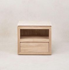 a small wooden table with one drawer open