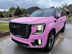 a pink truck is parked on the street