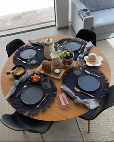 the table is set with plates, silverware and other things to eat on it