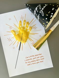 a birthday card with a hand holding a sparkler on it and a happy new year's greeting