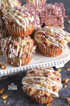 several muffins with white icing on top of each one and the words rhubarb streusel muffins above them