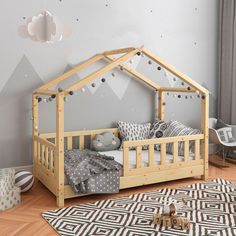 a child's bed with a wooden frame and canopy over it in a room