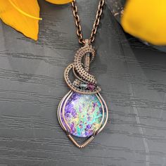 This pendant is made with a beautiful artisan-made fluid art centerpiece, with fluorite accent beads, wrapped in bare copper wire that has been oxidized and polished. It measures 2.25 x 1 inches, making it a medium-to-large sized pendant. The necklace chain is also oxidized and polished copper and comes in a variety of lengths to suit your needs. STONE INFO:  This jewelry piece is made with a glass cabochon centerpiece with fluid art made by an artist in Vermont. Truly "wearable art". COPPER JEW Purple Wire Wrapped Copper Wire Necklace, Bohemian Iridescent Wire Wrapped Necklace, Boho Handmade, Steel Wool, Beads Handmade, Necklace Boho, Jewelry Unique, Purple Glass, Hardware Store