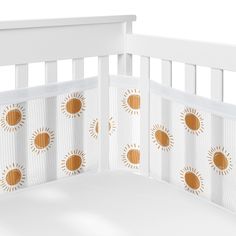 a white crib with gold sunbursts on it