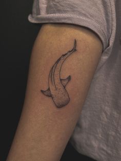 a woman's arm with a banana tattoo on the left side of her body