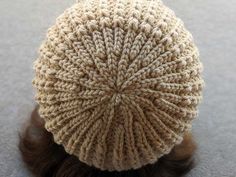 there is a knitted hat on top of a woman's head in the floor