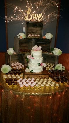 a table topped with lots of cupcakes and cakes