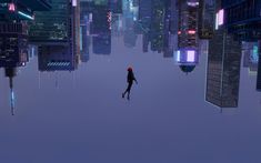 a person standing in the middle of a city with tall buildings and skyscrapers at night