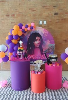 a table topped with cakes and balloons on top of a checkered cloth covered floor