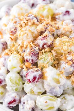 a white bowl filled with fruit salad and covered in toppings on top of a table