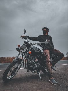 a man sitting on top of a motorcycle