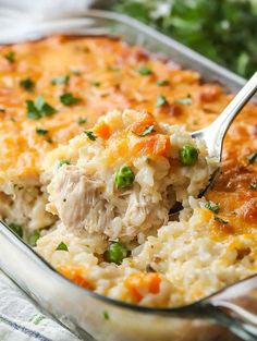 a casserole dish filled with chicken and rice, garnished with parsley