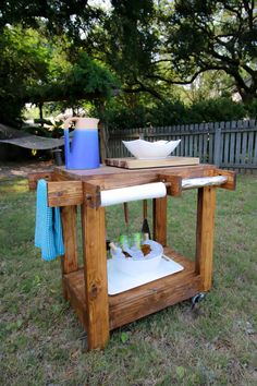 an outdoor kitchen made out of pallets and wood with two bowls on the table