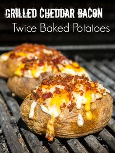 two baked potatoes sitting on top of a grill