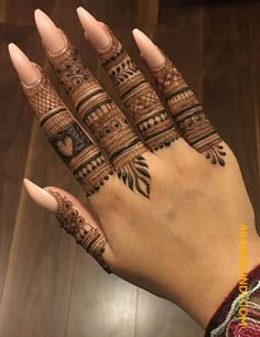 a woman's hand with henna tattoos on it