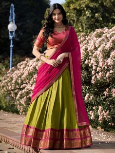 Introducing our stunning "excellent green zari weaving kanchipuram silk event wear lehenga choli" that is sure to make you stand out at any special occasion. This set includes a green color Kanchipuram silk lehenga with intricate zari weaving work, a pink color Kanchipuram silk choli also with zari weaving work, and a pink color georgette plain dupatta with lace border work.
The green lehenga is beautifully stitched up to 42 inches, with a 3.70-meter flair, and un-stitched choli material of 0.80 Half Saree Designs South Indian, Kanchipuram Lehenga, Pink Half Sarees, Silk Half Saree, Onam Outfits, Lehenga Choli Designs, Simple Lehenga, Half Saree Lehenga, Sari Design