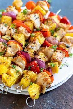 chicken and pineapple kabobs on a white plate