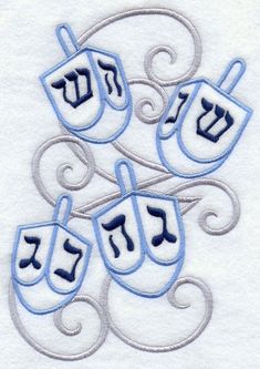 an embroidered design with blue and silver letters on white fabric, depicting the hebrew symbol