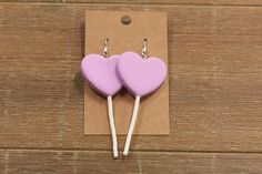 Approximately 3 inches, not including earring hook, these earrings dangle and do not lay directly on the earlobe. They are 2 different colors which include pink and purple. They lay facing forward. Pink Heart Earrings For Birthday, Trendy Heart-shaped Earrings For Birthday, Trendy Heart Earrings For Birthday, Trendy Heart-shaped Birthday Earrings, Purple Heart-shaped Earrings For Pierced Ears, Purple Heart-shaped Pierced Earrings, Trendy Purple Heart Earrings As Gift, Trendy Purple Heart Earrings For Gift, Trendy Purple Heart Earrings