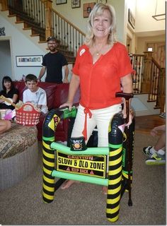 a woman standing on top of a inflatable chair with people sitting behind her