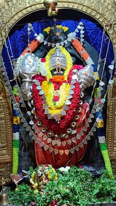 the statue is decorated with flowers and decorations