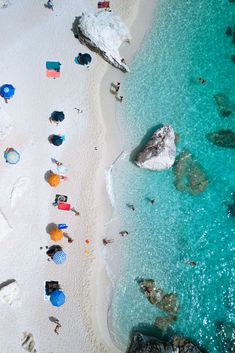 an aerial view of the beach with people on it