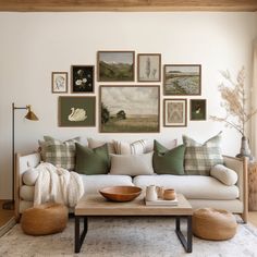 a living room filled with lots of furniture and pictures on the wall above it's coffee table