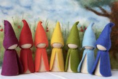 seven colorfully colored gnomes lined up in a row