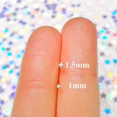 two fingers are marked with the same size as each other, and one finger has three small stars on it