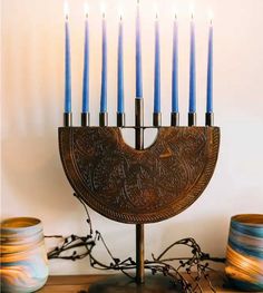 a menorah with five lit candles in it