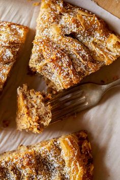 a piece of pie with powdered sugar on top and a fork next to it