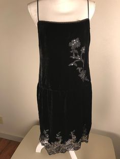 A very pretty Betsey Johnson black velvet evening dress with lace and sequins. It is sleeveless with adjustable spaghetti straps and a side zipper. A beautiful lace with sequins design graces the front and the hem line. It is a size 10.  It is in very good preowned condition. Measurements are taken with garment laying flat.  17 inches underarm to underarm  17 inches across waist line  20 inches across hip line  29 inches length from top of bodice to hem. Please check measurements carefully as I Sleeveless Velvet Evening Dress For Night Out, Party Velvet Dress With Lace Trim, Velvet Lace Trim Dress For Party, Velvet Dress With Lace Trim For Party, Elegant Sequined Velvet Dress, Sequined Velvet Evening Dress, Velvet Evening Dress With Lace Trim, Black Velvet Sequin Dress, Velvet Evening Dress