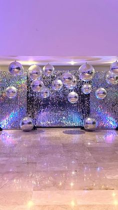 an empty room with disco balls on the floor and lights in the ceiling behind it