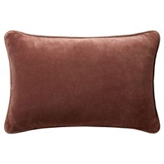 a brown velvet pillow on a white background