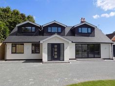 a white house with black shutters and windows