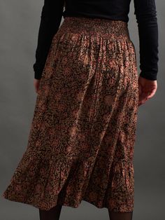 This cotton ruffle skirt features a chic midi length, a flat front, and elastic waistband in back for the perfect style and comfort combo. The standout of this pull-on skirt is its gorgeous hand block printed fabric with black, green and red tones. 100% Cotton Hand block printed Kalamkari Hidden pockets Elastic smocking at back waist Length of size M is 32" Made fair trade in India by one of our longstanding production partners This textile has been printed by hand using traditional techniques. Midi Skirt Black, Block Printed Fabric, Fair Trade Clothing, Indigo Dye, Black Midi Skirt, Block Printing Fabric, Floral Color, Perfect Style, Green And Red