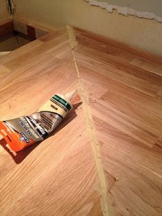 a tube of toothpaste sitting on top of a wooden floor