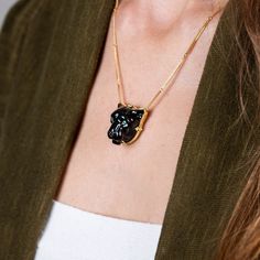 This glossy black Obsidian was hand-carved into a powerful, black panther and brought to life with sparkling Emerald eyes. This wild cat embodies grace and courage. We encased it in an 18k gold bezel with braided detail and prongs. Obsidian is considered to be a highly protective stone so wear it as a protection amulet. One of a kind. Technical Details Metal: 18k yellow goldRainbow Obsidian: 40.52 cts. Emerald EyesChain: can be worn at 16" and 18"Pendant Size: 24 x 22mmClosure: lobster claspHand Elegant Black Hand Forged Necklace, Formal Hand Forged Black Jewelry, Formal Black Hand Forged Jewelry, Handmade Luxury Black Jewelry, Luxury Handmade Black Jewelry, Black Panther Necklace, Panther Necklace, Mixed Metal Bracelets, Textile Necklace