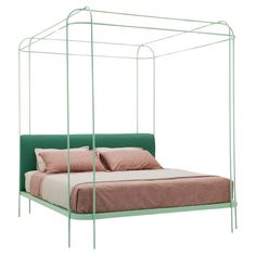 a bed with a green metal frame and pink pillows on the bottom, in front of a white background