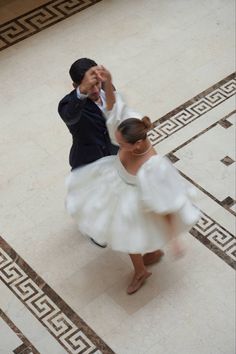 a man and woman dancing on the floor