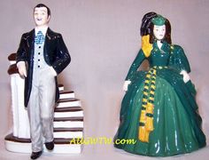 two figurines of people dressed in formal clothing