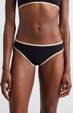 Sleek and sustainable, these minimalist bikini bottoms set off with contrast trim are made from fully lined stretch jersey. Lined 71% recycled polyamide, 29% elastane Machine wash, dry flat Made in Portugal Designer Clothing Fitted Swimwear With Contrast Trim, Sporty Black Swimwear With Contrast Trim, Black Sporty Swimwear With Contrast Trim, Black Swimwear With Contrast Trim For Beachwear, Black Beachwear Swimwear With Contrast Trim, Black Beach Swimwear With Contrast Trim, Stretch Swimwear With Contrast Trim For Poolside, Swim Bottoms, Beach Vibe