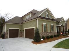 a large house with two garages in front of it