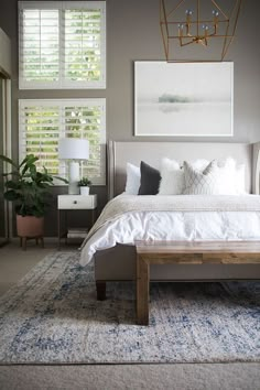 a large bed sitting in the middle of a bedroom