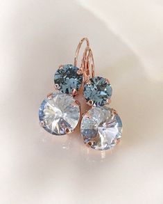 Pretty pair of earrings featuring 12mm round dusty blue and 8mm round steel blue crystals. Lever back earring closure for pierced ears. 1 1/2 inches long. Shown with the rose gold finished metal. Available in various metal finishes. Please select from the drop down menu at checkout. Thanks for stopping by! Wedding Jewelry Blue, Blue Earrings Wedding, Blue Bridal Earrings, Something Blue Bridal, Crystal Teardrop Earrings, Blue Crystal Earrings, Special Occasion Jewelry, Earrings Bridesmaid, Blue Bridal