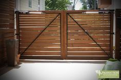 an open wooden gate in front of a house