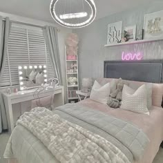 a bedroom decorated in pink and grey with white bedding